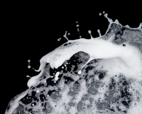 Foam splash launch isolated on black background,soap shampoo stop motion